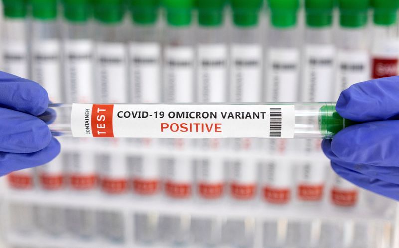 Illustration shows test tube labelled “COVID-19 Omicron variant test positive