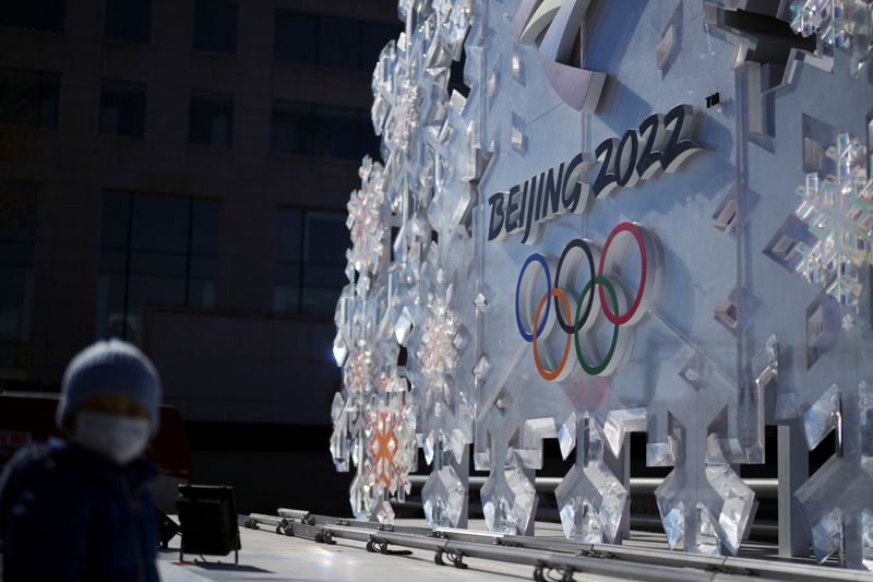 Person stands near a Beijing 2022 installation outside the closed-loop