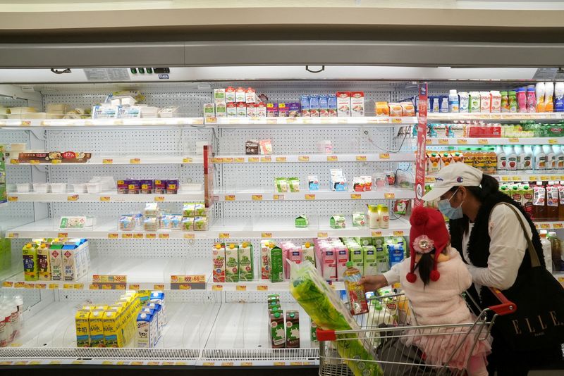 FILE PHOTO: Customers shop at a supermarket, following the outbreak