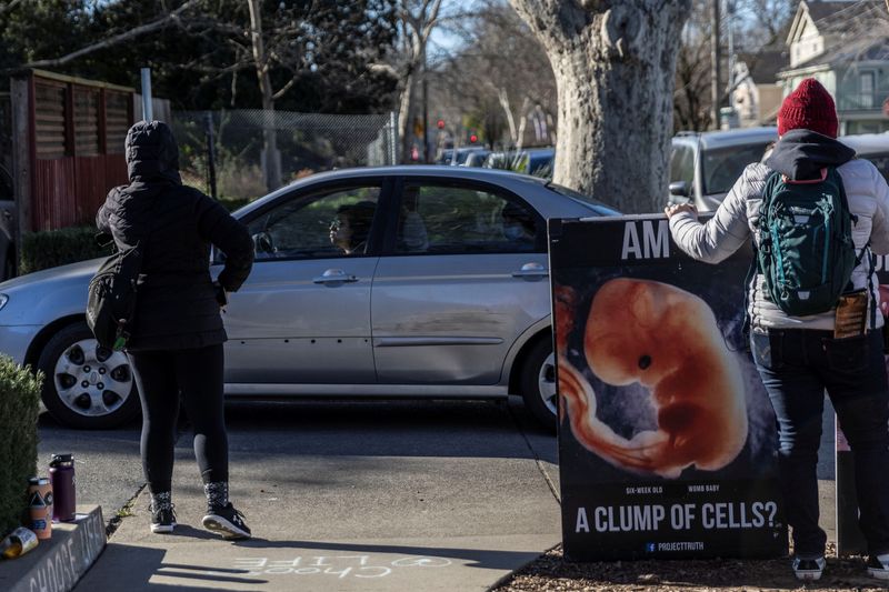 Local residents attend a weekly protest outside the Planned Parenthood