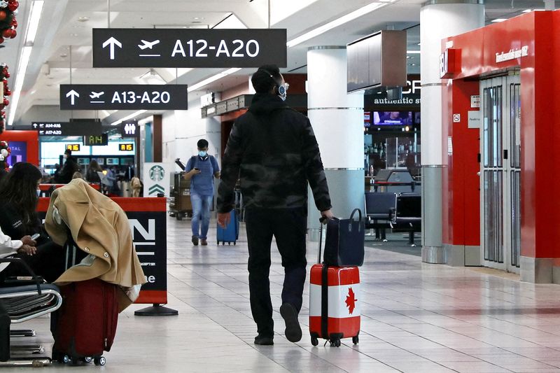 FILE PHOTO: United States-bound passengers walk in Toronto Pearson Airport