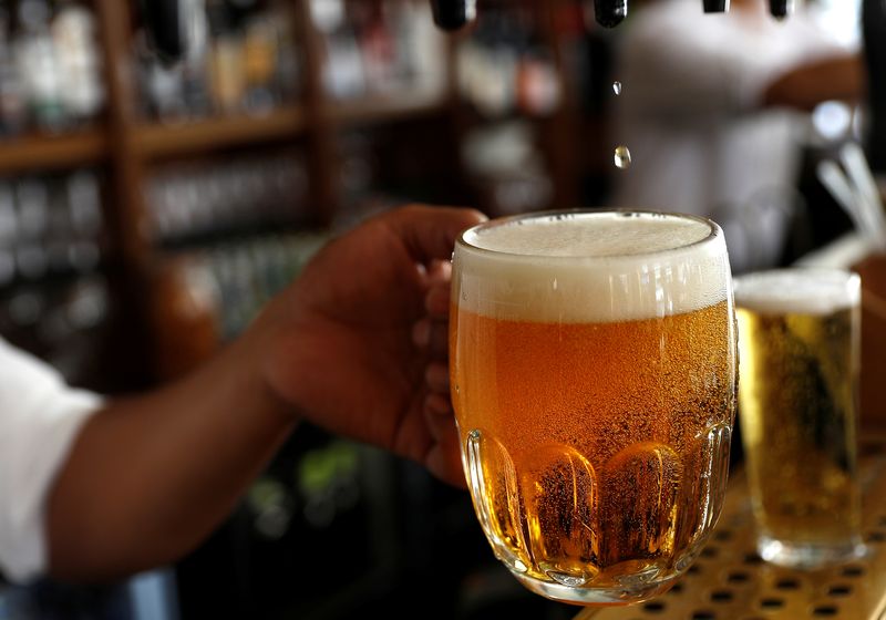 A pint of beer is poured into a glass in