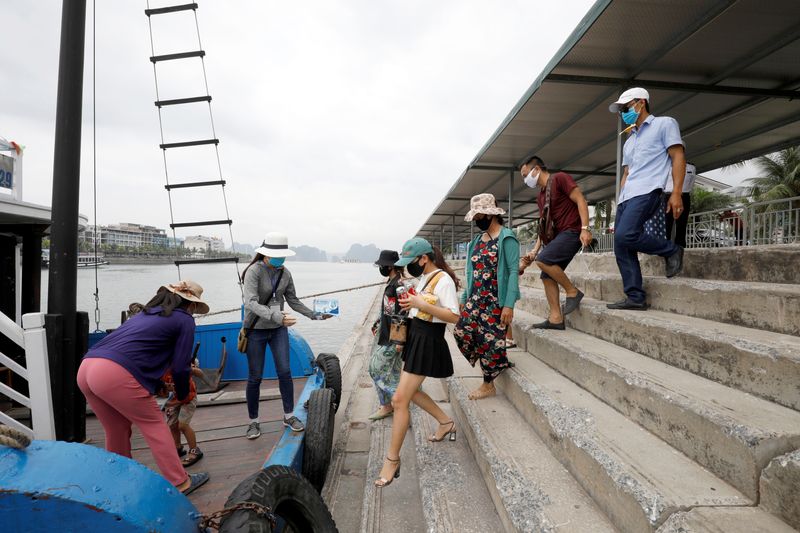 Vietnamese tourists visit Ha Long bay after the Vietnamese government