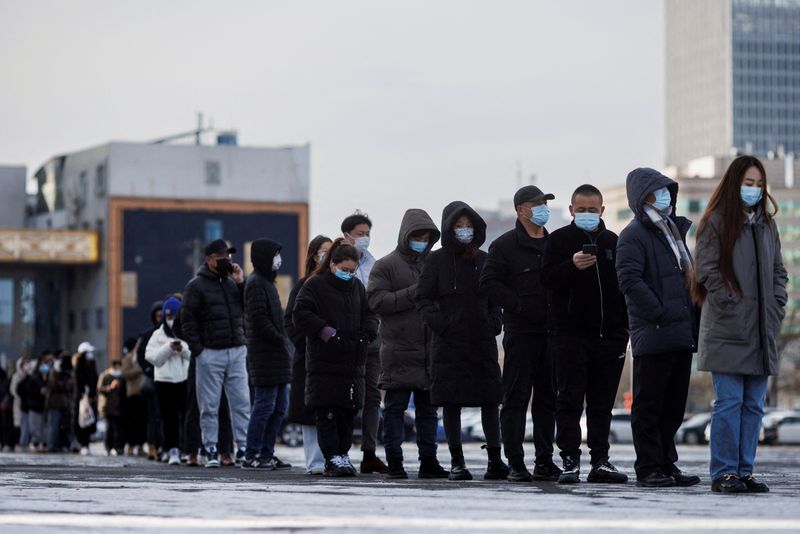 FILE PHOTO: People line up to get throat swab test