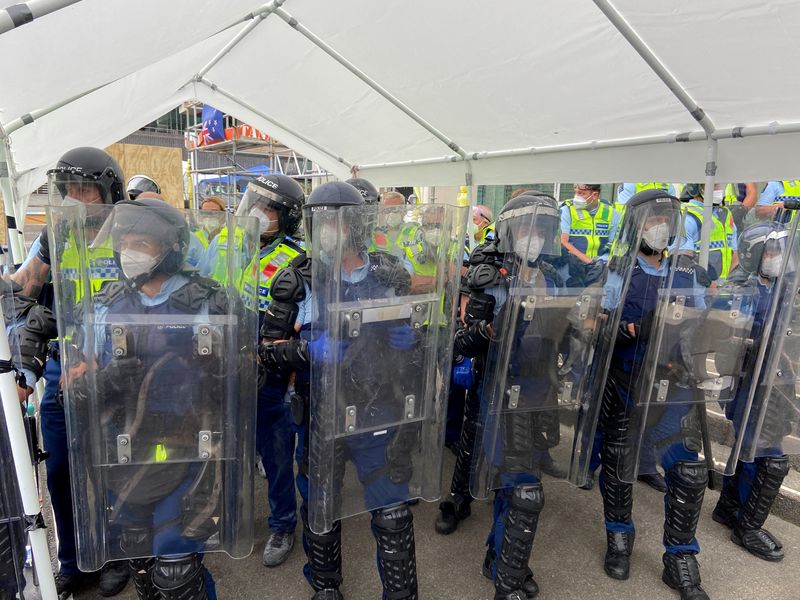 FILE PHOTO: Police stand guard as protesters gather  in