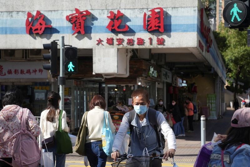 People wearing face masks cross a street, following the coronavirus