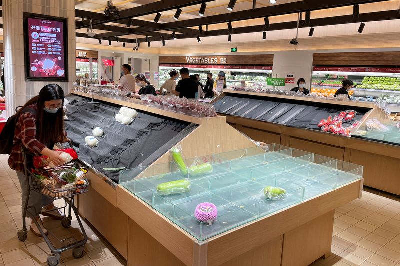 Customers shop at a supermarket in Beijing