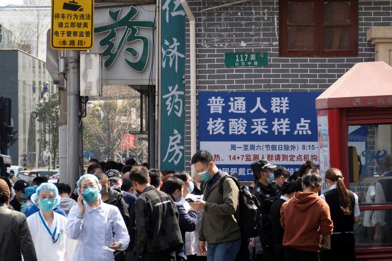 Residents line up outside a nucleic acid testing site of