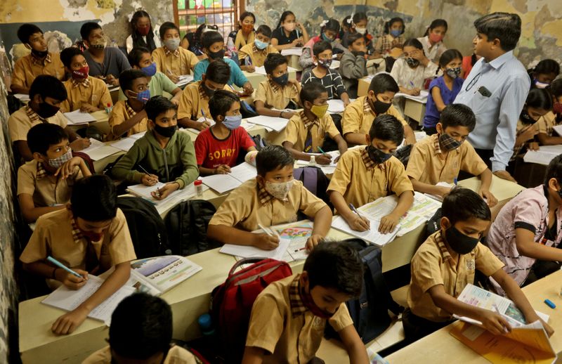 Schoolchildren attend class after the majority of schools were reopened
