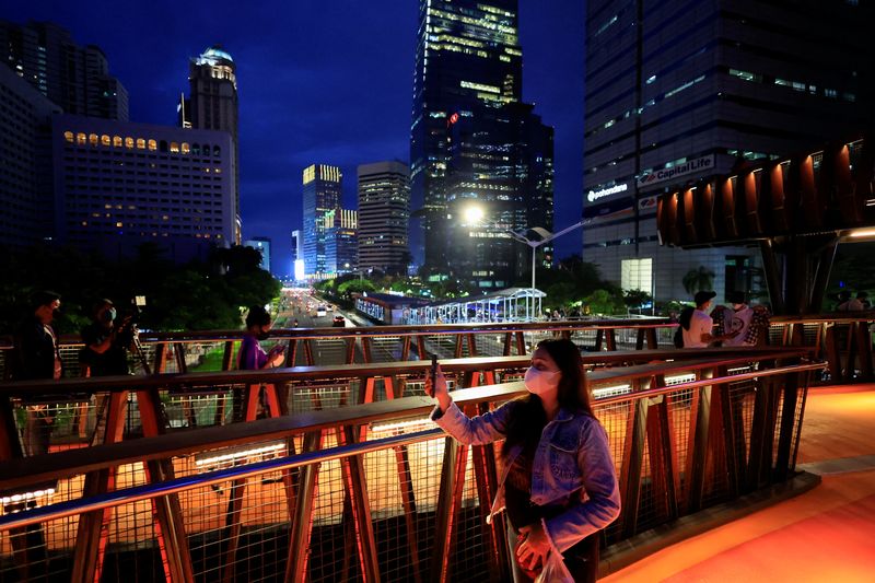 FILE PHOTO: People enjoy a pedestrian bridge during the dusk