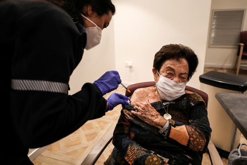 Senior citizens receive a fourth dose of the COVID-19 vaccine