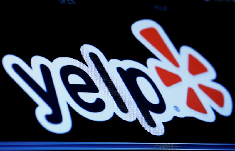 The company logo for Yelp! is displayed on a screen