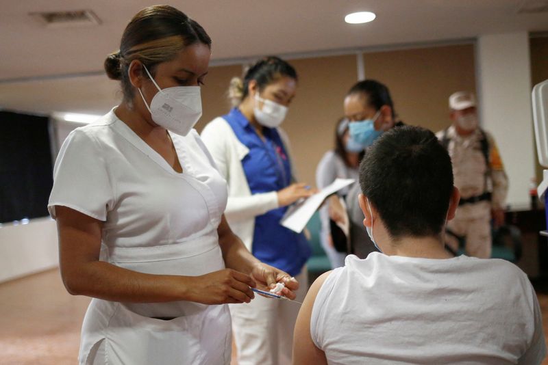 FILE PHOTO: Children receive vaccination against the coronavirus disease (COVID-19)