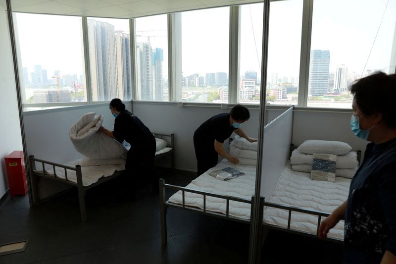 FILE PHOTO: Workers convert an office building into a makeshift