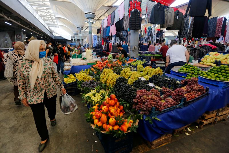 FILE PHOTO – People shop at a local market in