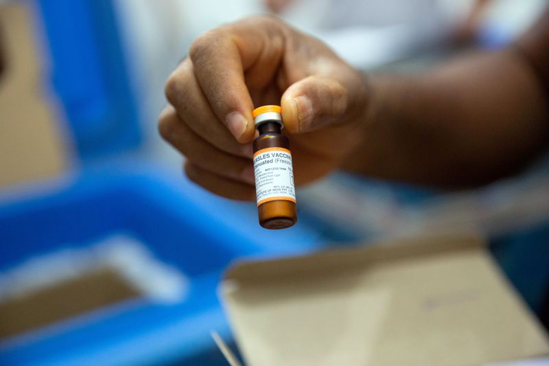 FILE PHOTO: A vial of measles vaccine is checked at