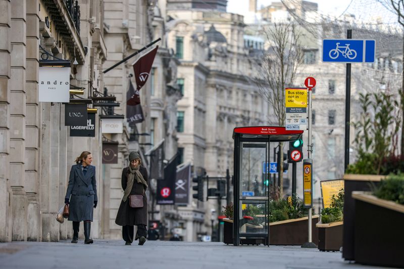 FILE PHOTO: Two women walk down Regent Street in London