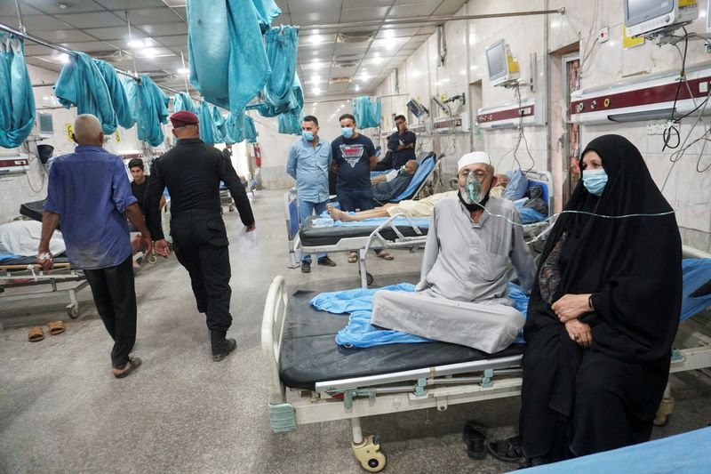 Iraqi people receive oxygen support at a hospital during a