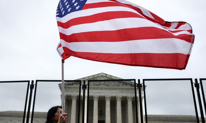 An anti-abortion protester waves a flag in front of the