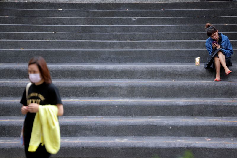 FILE PHOTO: Woman sits on a staircase in Taipei