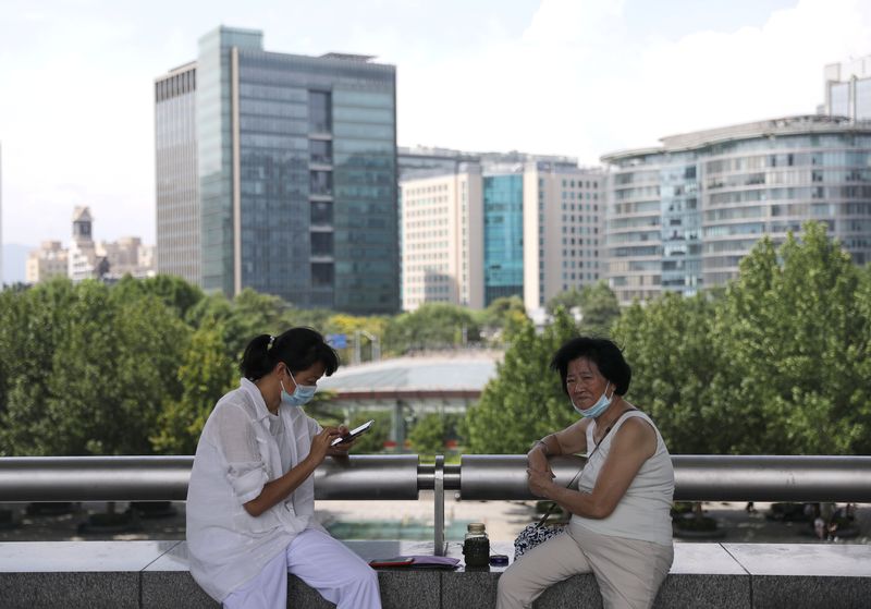 People rest at a square at Beijing’s tech hub Zhongguancun