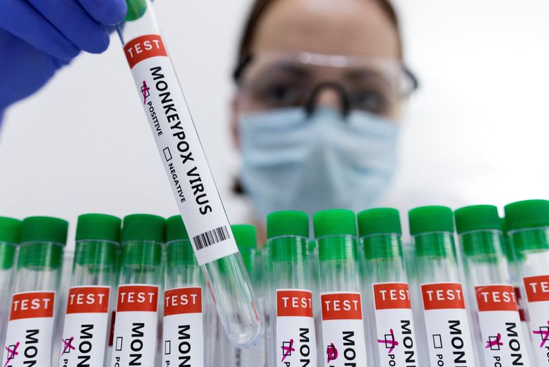 Illustration shows test tubes labelled “Monkeypox virus positive