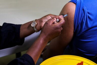 A healthcare worker administers the  Pfizer coronavirus disease (COVID-19)