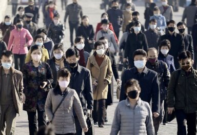 People wearing protective face masks commute amid concerns over the