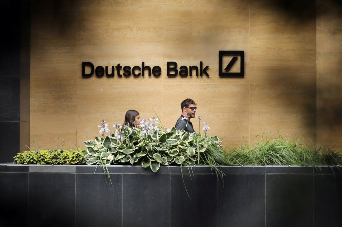 FILE PHOTO: People walk past a Deutsche Bank office in