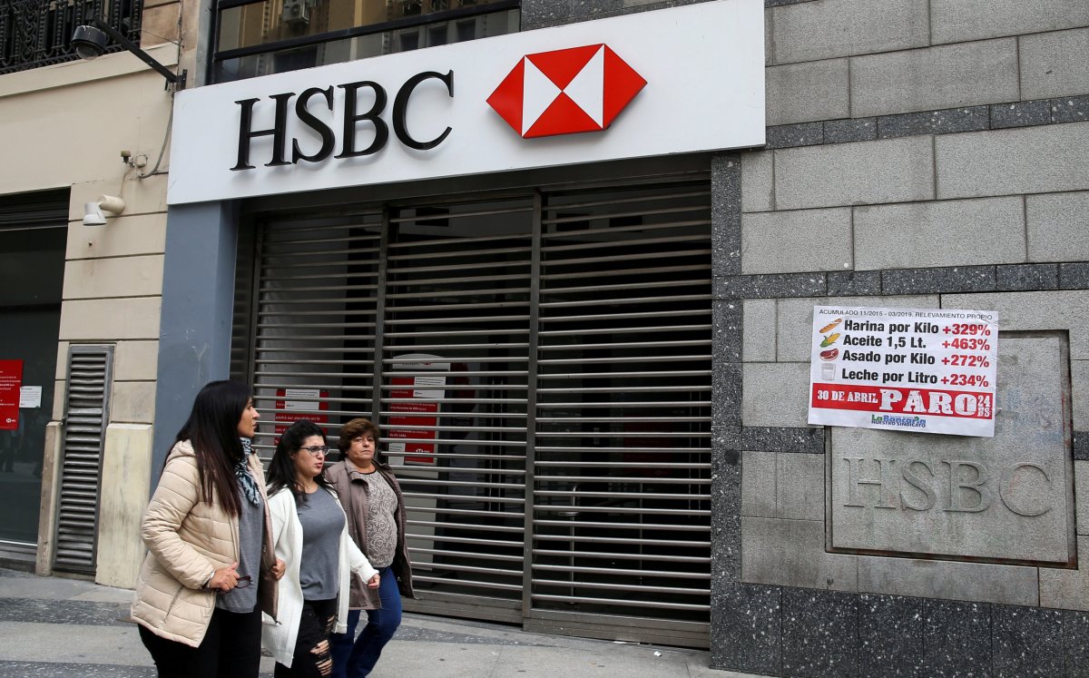 Pedestrians walk past closed HSBC bank during a national strike