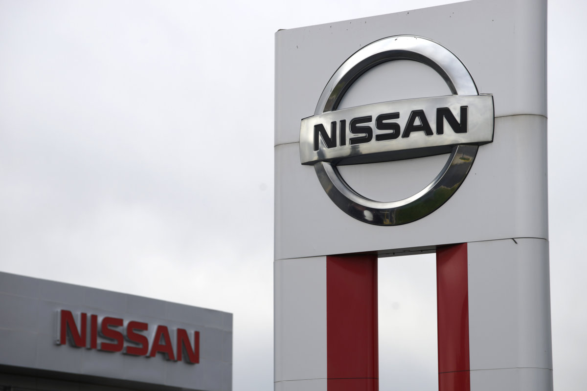 Nissan signs are seen outside a Nissan auto dealer in