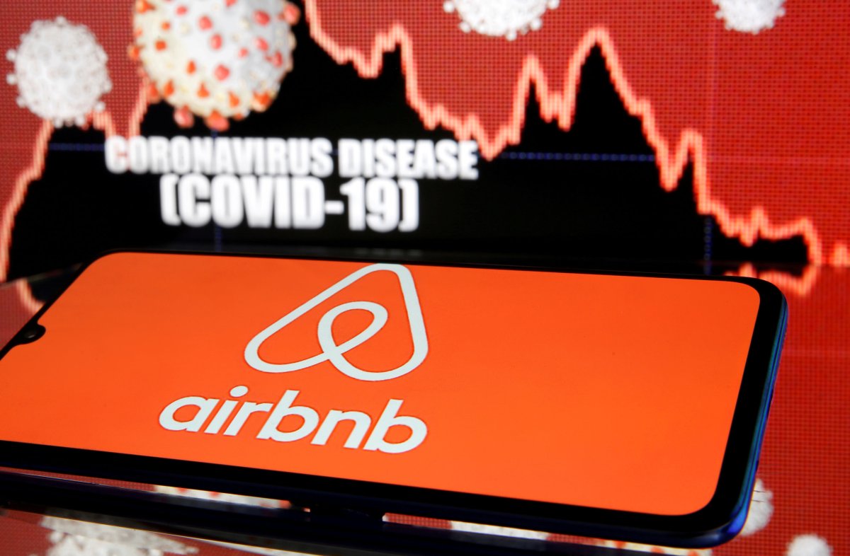 FILE PHOTO: Airbnb logo is seen in front of diplayed