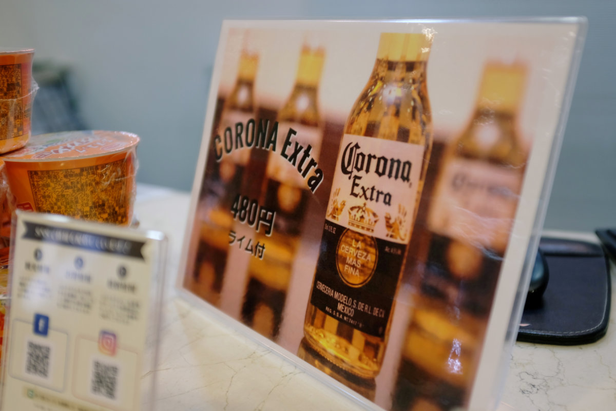 FILE PHOTO: A sign advertising discounted Corona beers is displayed