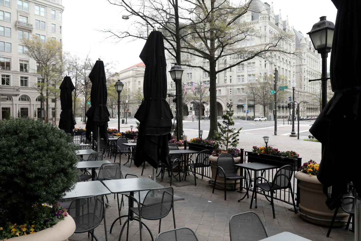 FILE PHOTO: Empty restaurant tables sit on a plaza on