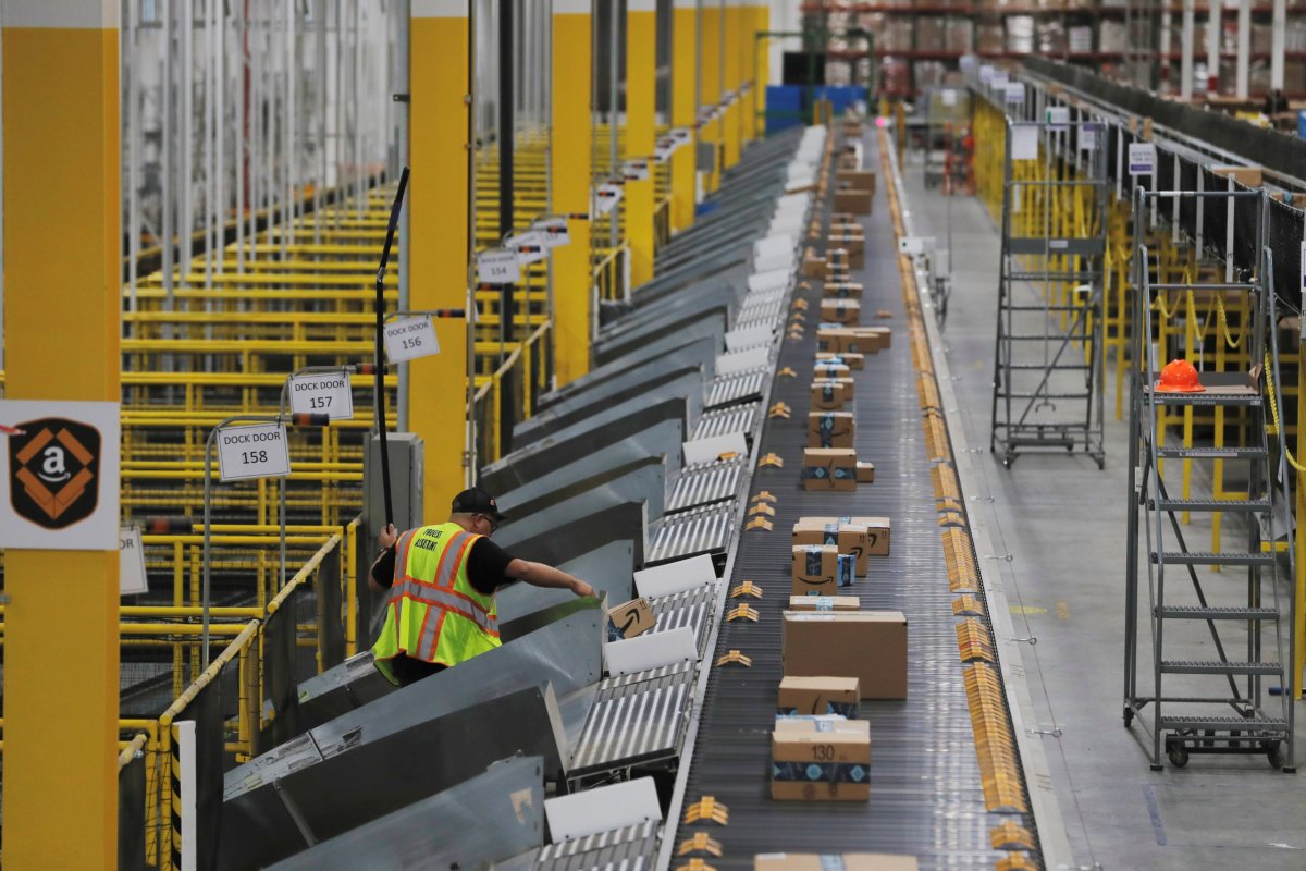 FILE PHOTO: Amazon packages are pushed onto ramps leading to
