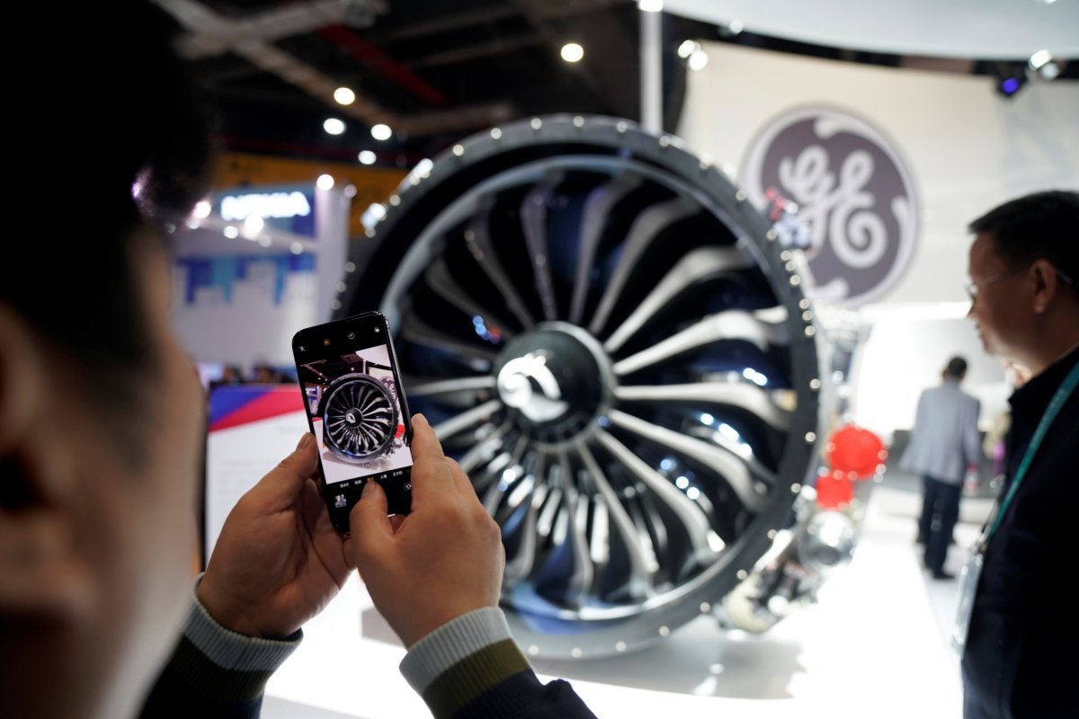 A man takes a picture of a General Electric (GE)