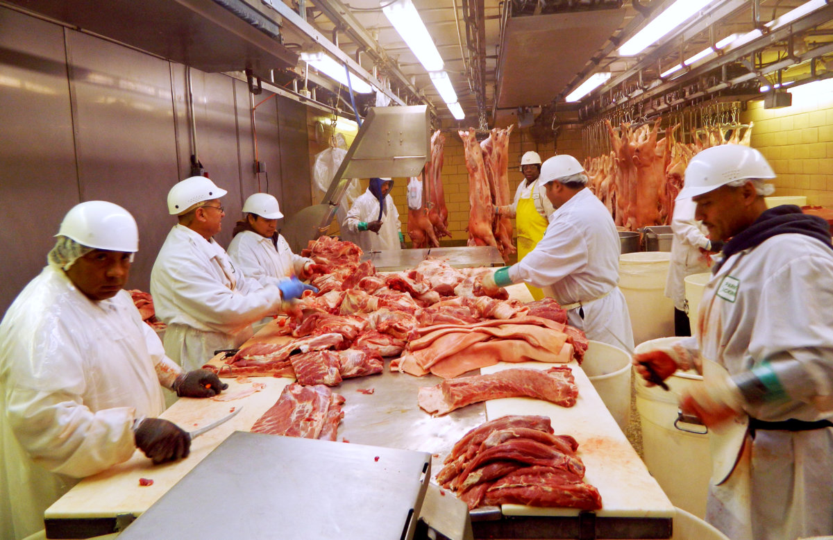 FILE PHOTO: Workers cut pork at Park Packing — one