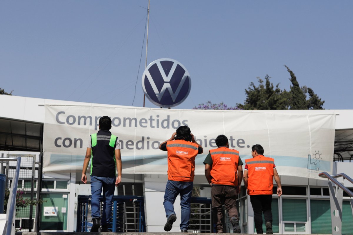 FILE PHOTO: Workers walk outside the Volkswagen (VW) plant as
