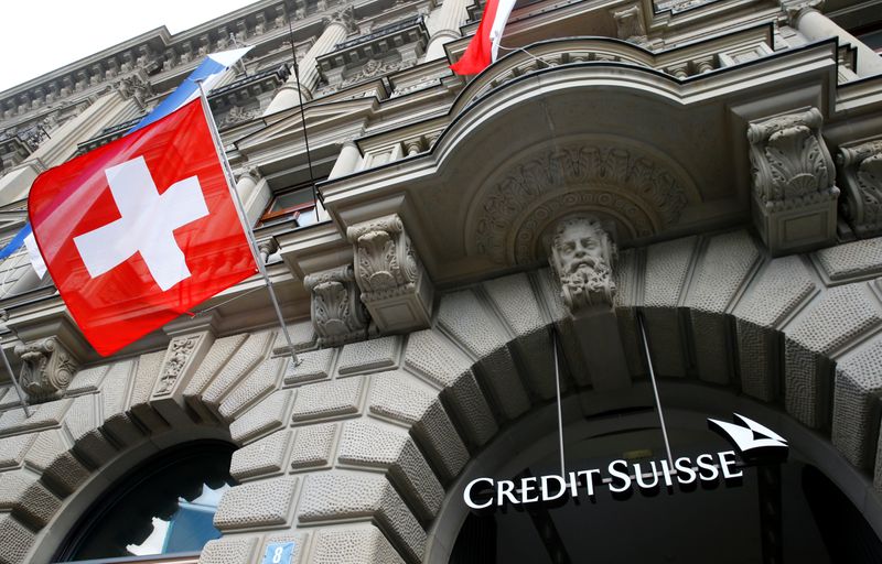 Switzerland’s national flag flies below a logo of Swiss bank