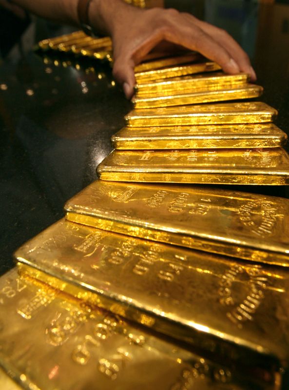 FILE PHOTO: Security guard places several one-kilo gold bars inside