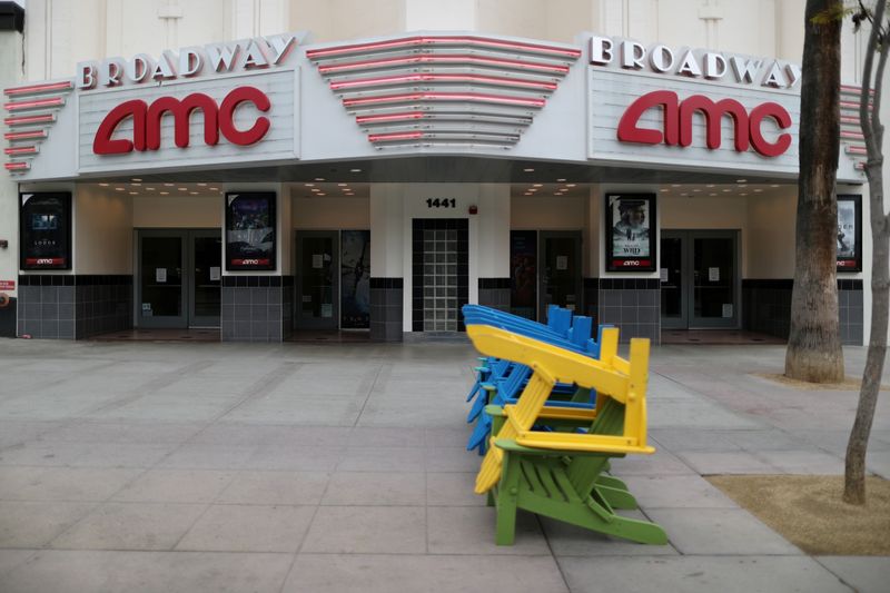 FILE PHOTO: Deckchairs sit stacked outside a closed movie theater