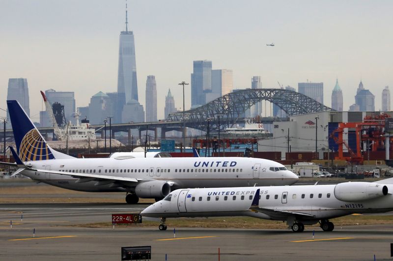 United Airlines passenger jets taxi with New York City as