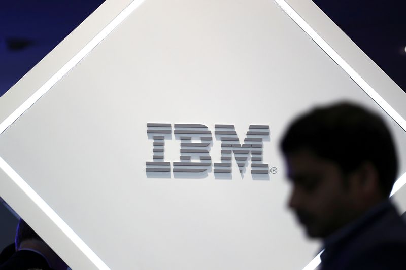 Man stands near an IBM logo at the Mobile World