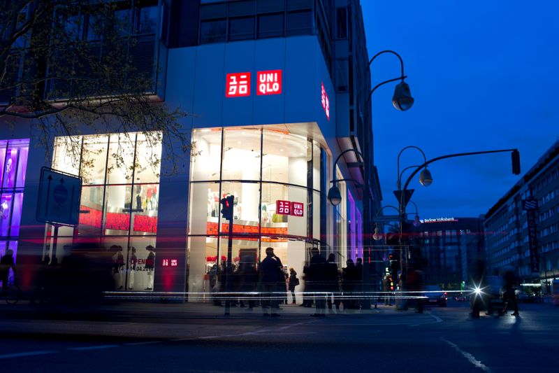 FILE PHOTO:  People stand outside of the Uniqlo Global