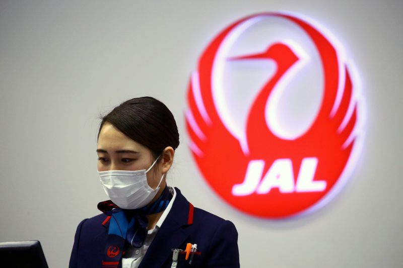 FILE PHOTO: An employee of Japan Airlines (JAL) is pictured