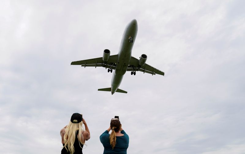 FILE PHOTO: Flight attendants photograph a plane landing in Washington