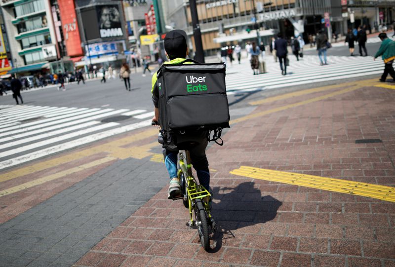 FILE PHOTO: An Uber Eats delivery person rides a bicycle