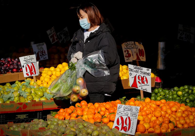 FILE PHOTO: A woman wears a mask and gloves as