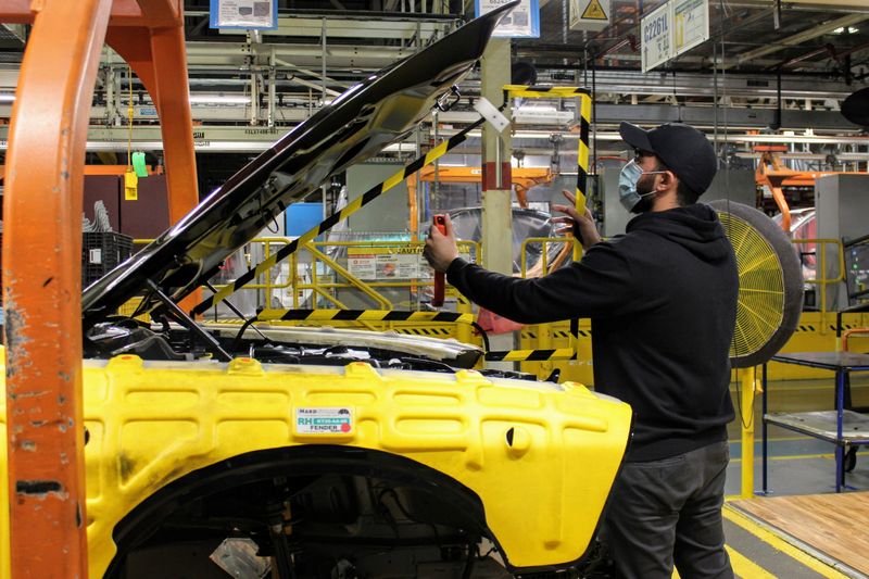 An operator at FCA’s Brampton Assembly Plant installs a removable