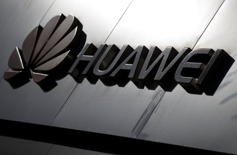 The Huawei brand logo is seen above a store of